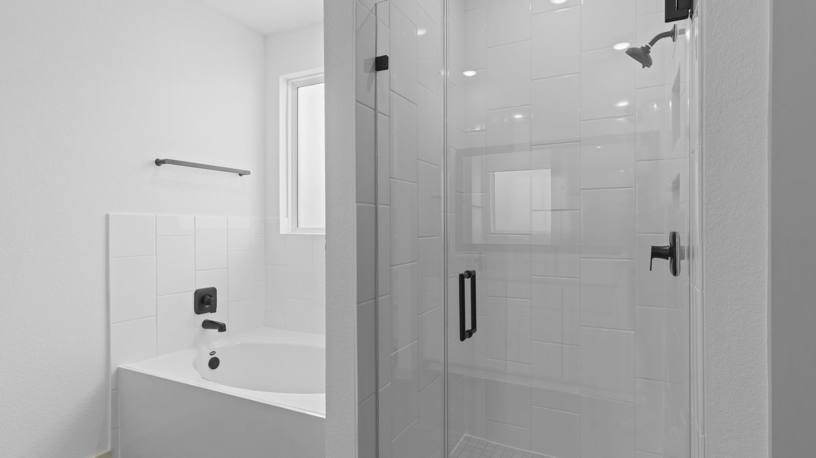 primary bathroom with one window and separate bathtub and shower