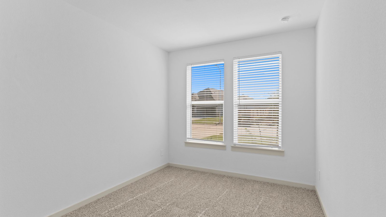 secondary bedroom with two large windows
