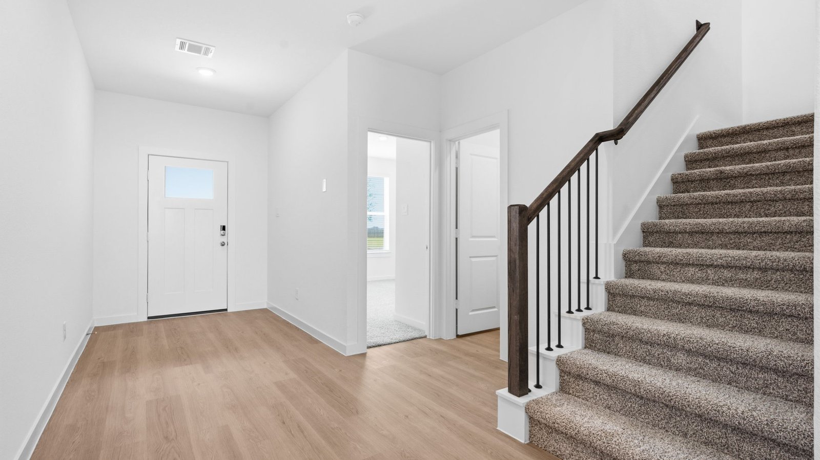 Spacious entry foyer with grand staircase leading to the second floor
