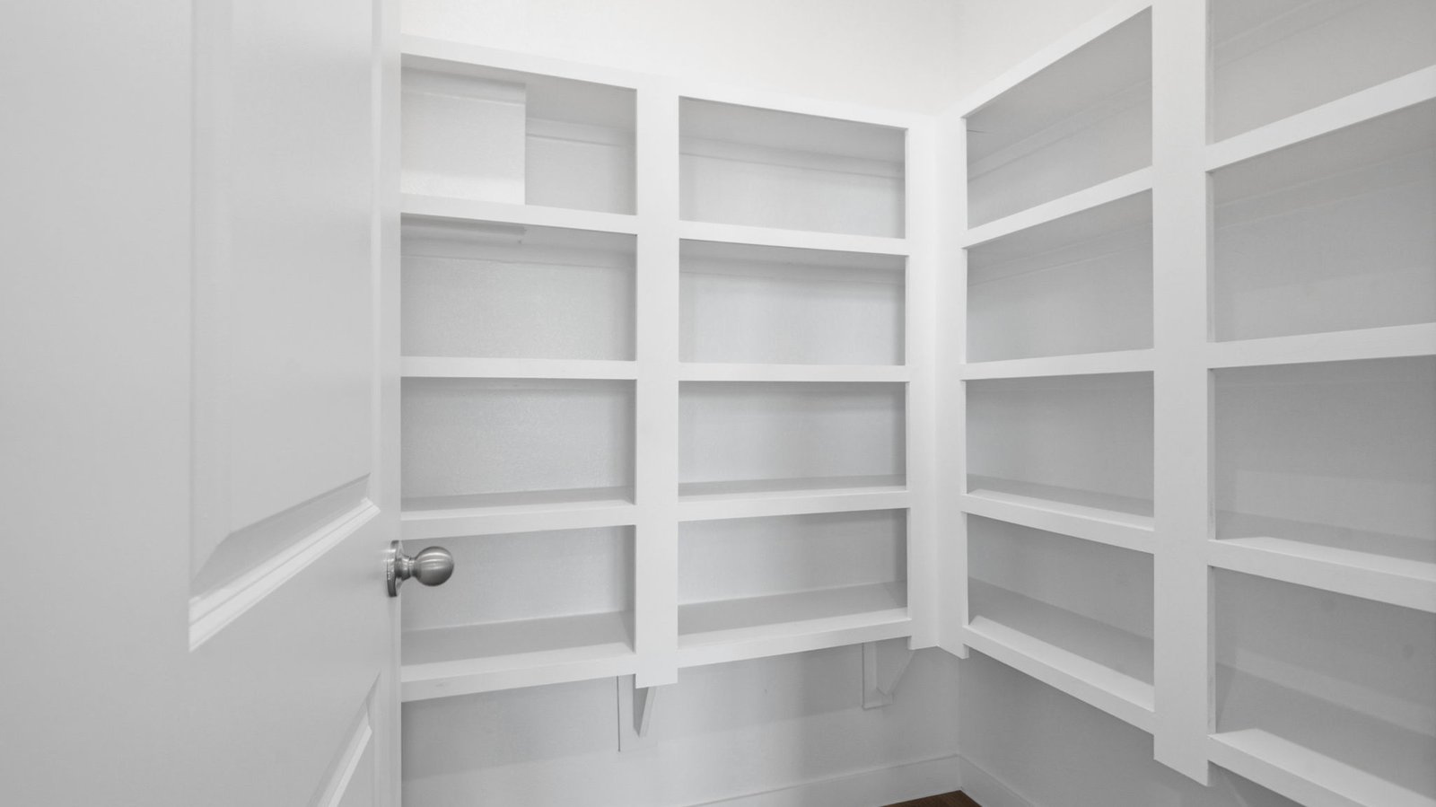 Walk-in pantry off the kitchen with built in shelves for maximum storage