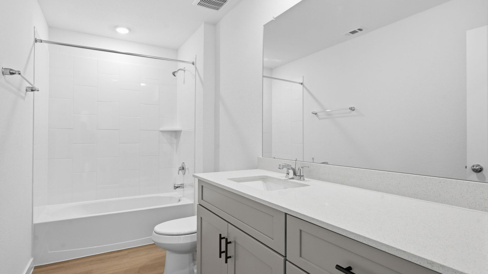 A well-designed bathroom equipped with quartz countertops, a standing tub, and a single vanity.