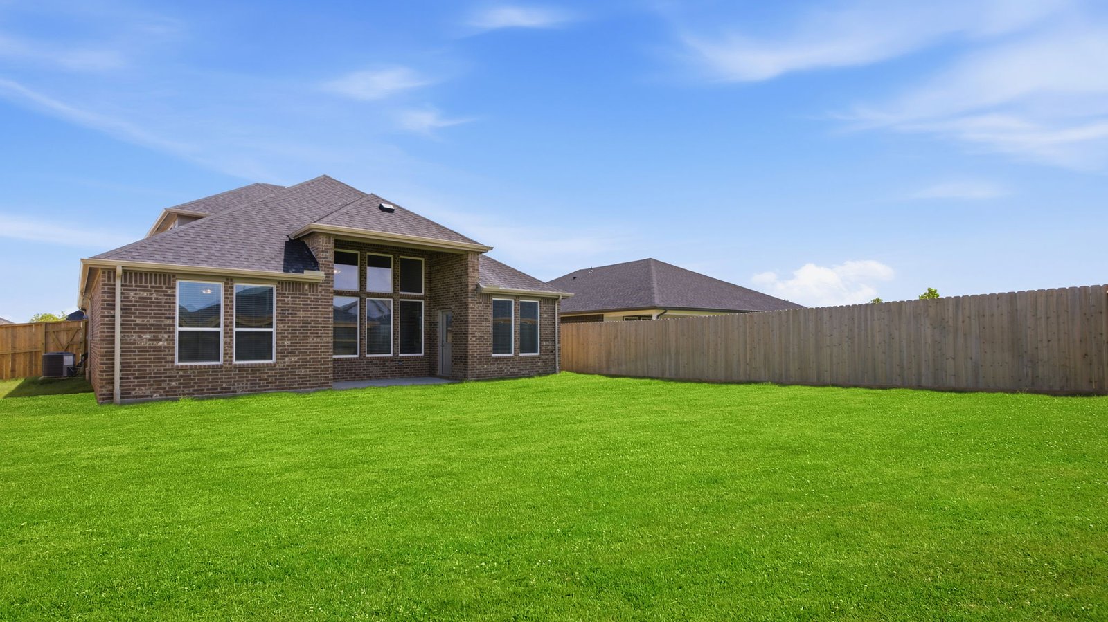 Large fenced-in backyard with a covered patio, perfect for outdoor entertaining.