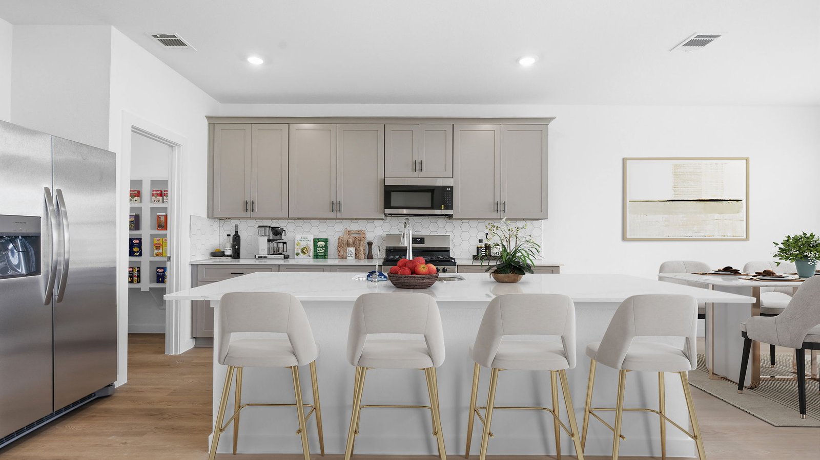 An open concept kitchen with an island with bar seating and access to the living and dining areas.