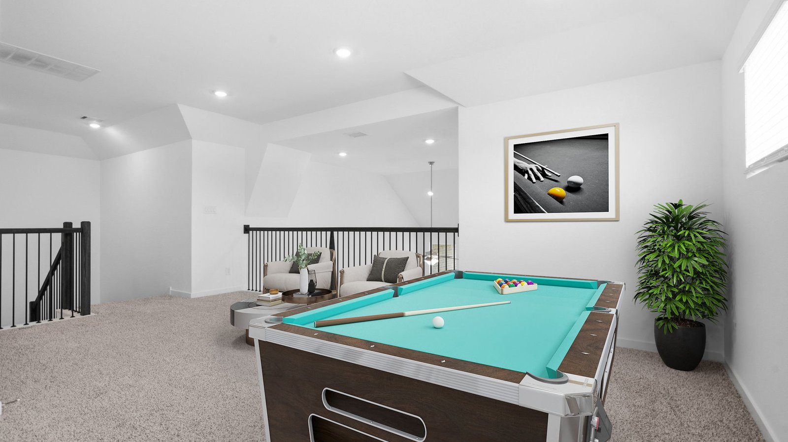 A spacious upstairs living area with plenty of natural light from windows overlooking side of the home