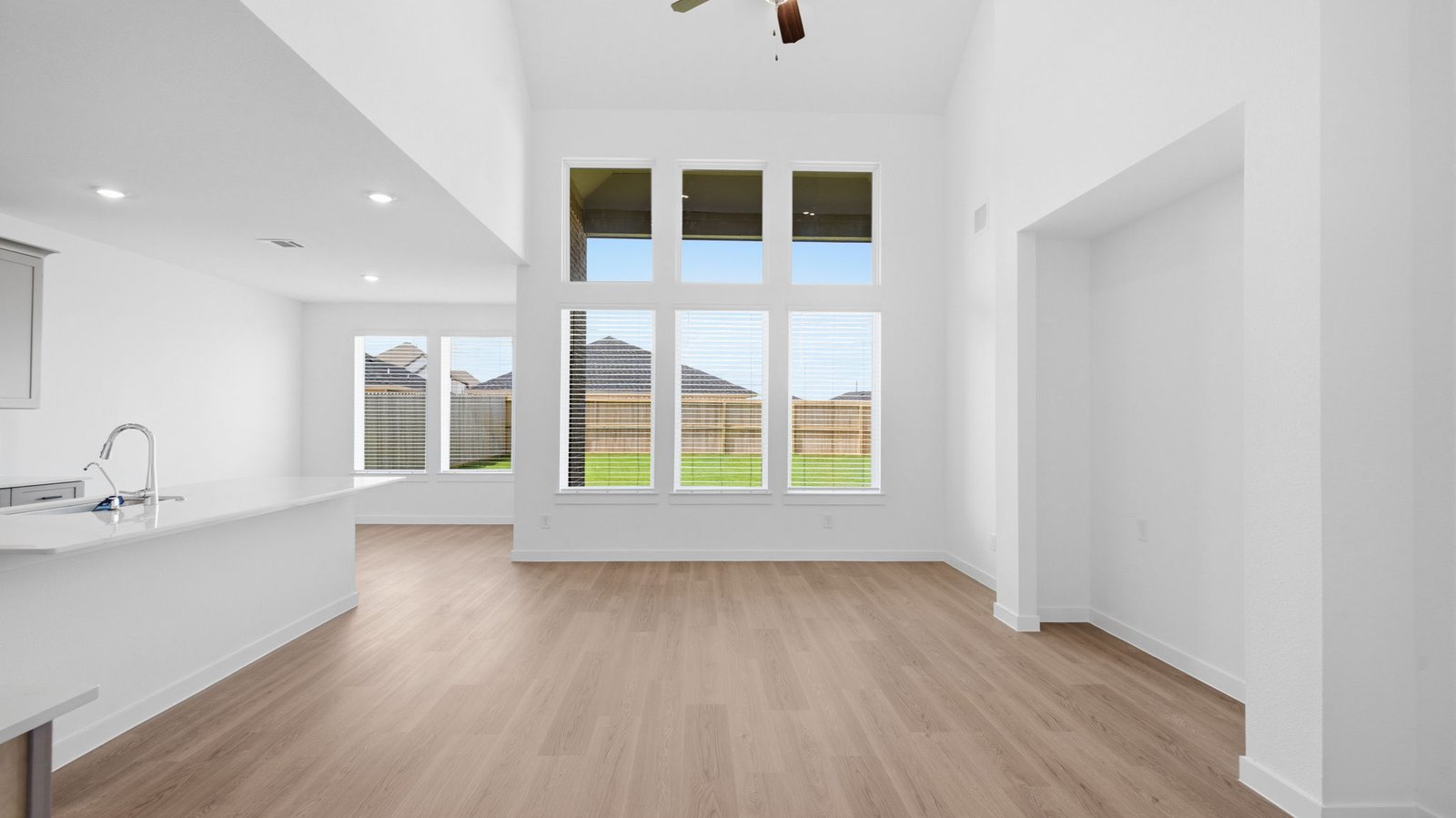 open concept living room with large windows and tall celling's