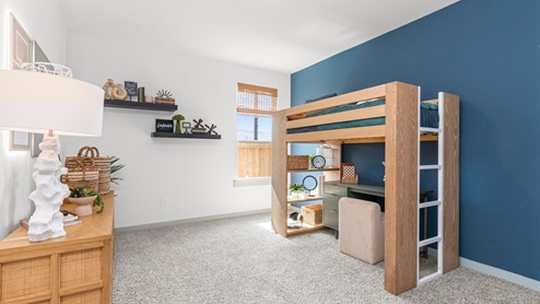 Bedroom three with carpeted floors and large single window for natural light.