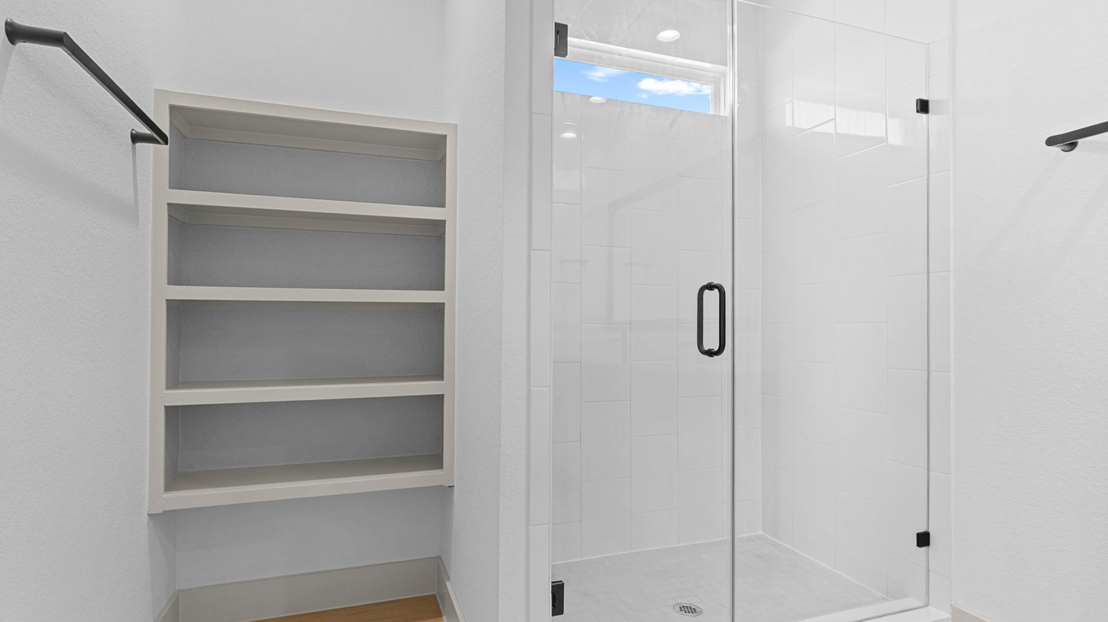 primary bathroom with shower and open shelving