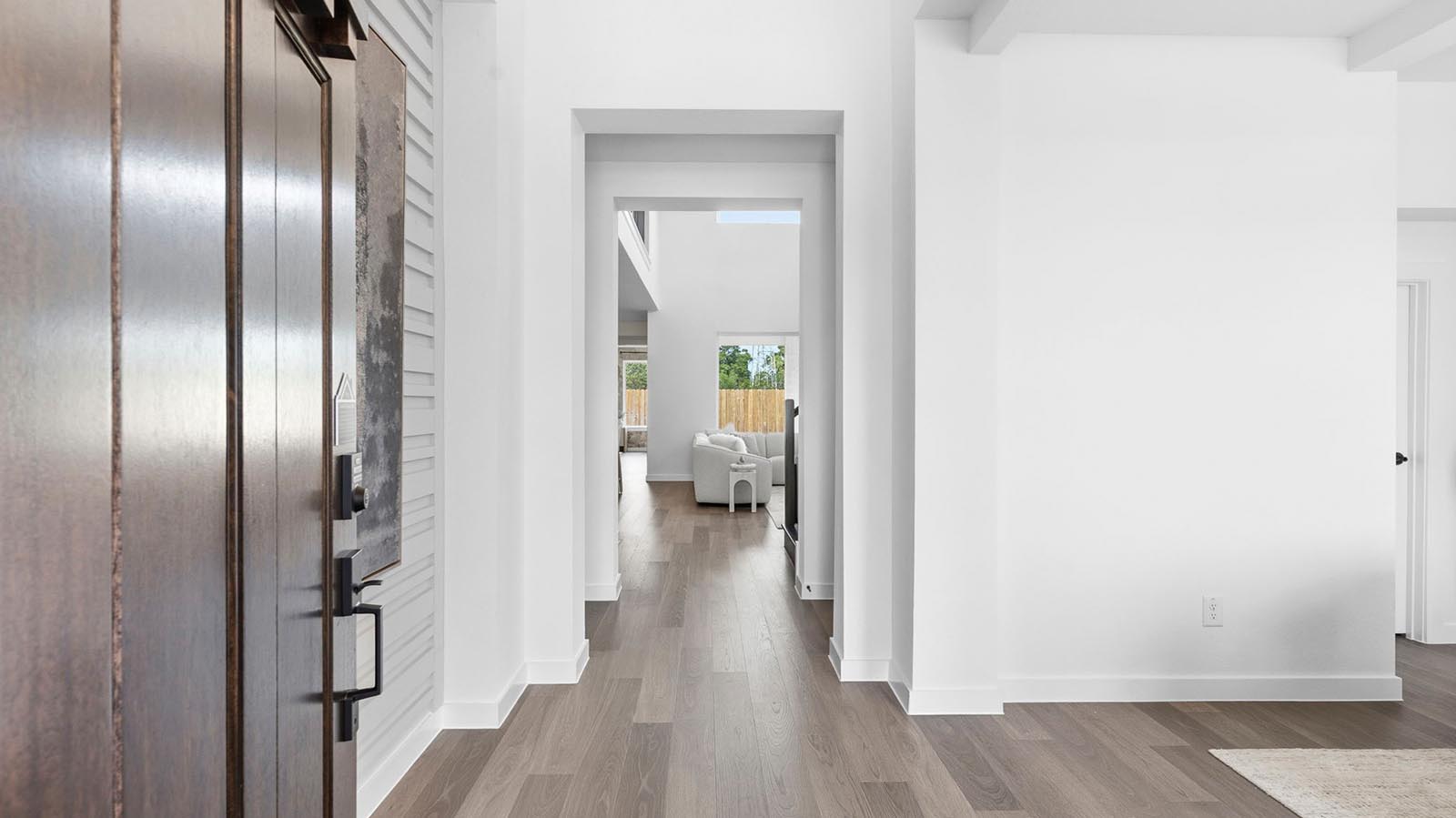 Entry hallway leading to living room and kitchen in the background.
