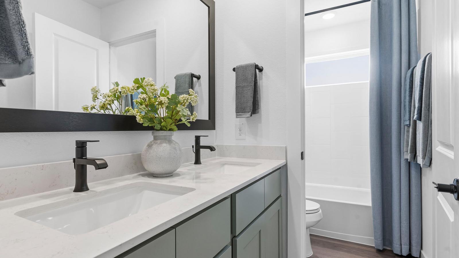 secondary full bathroom with two sinks