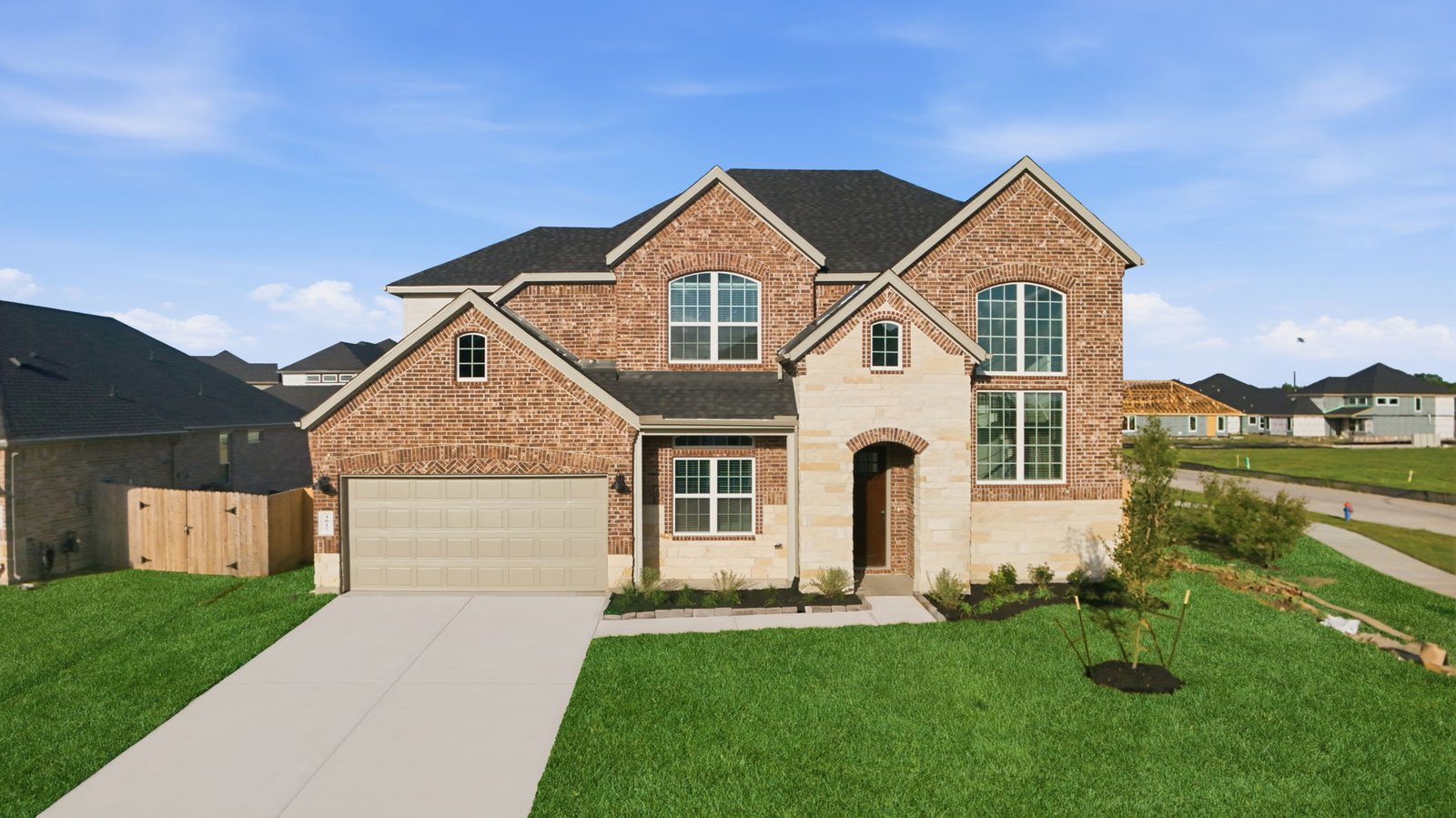 two story brick home with a three car garage