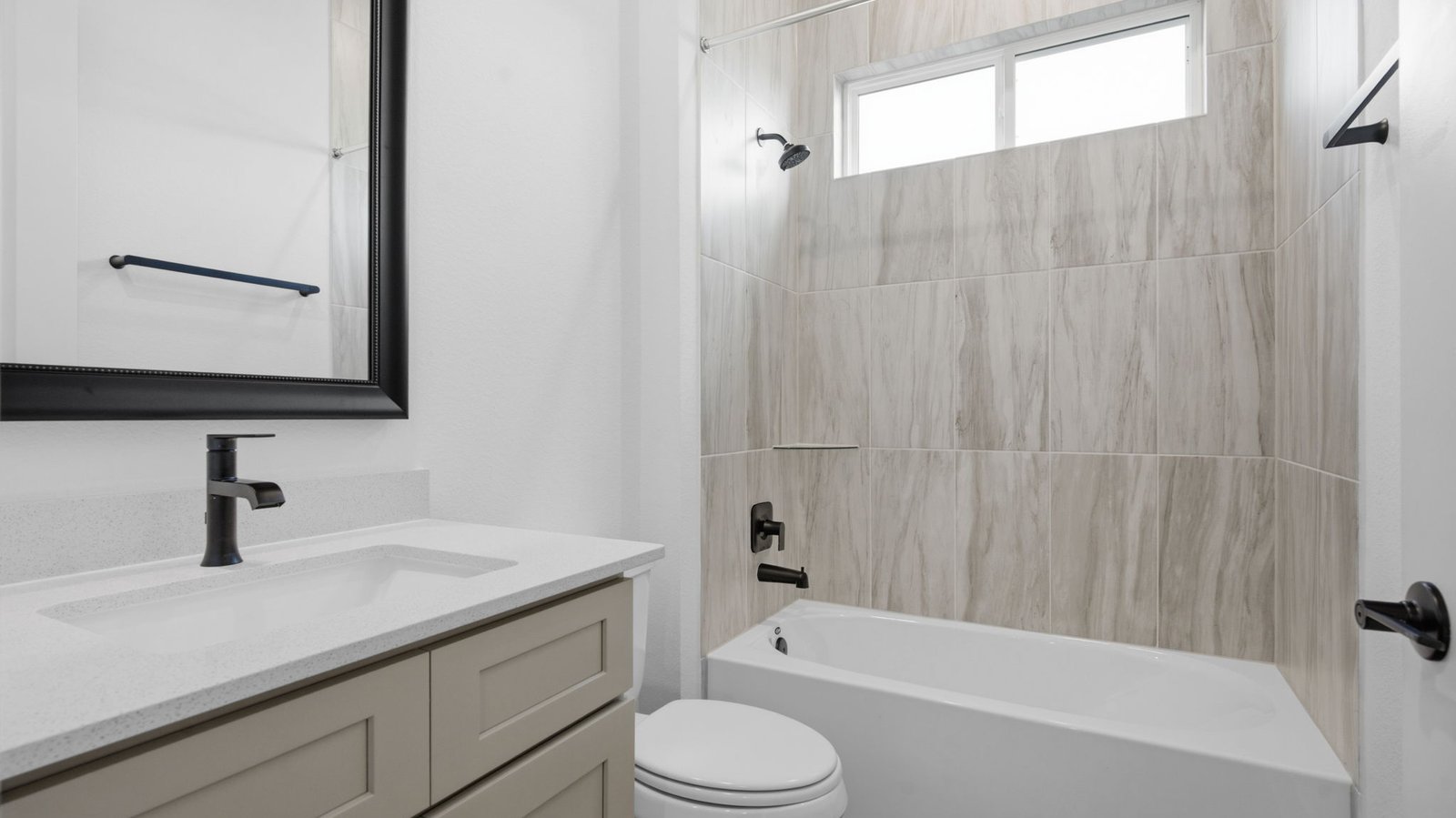A well-designed bathroom equipped with granite countertops, emphasizing functionality and contemporary style.