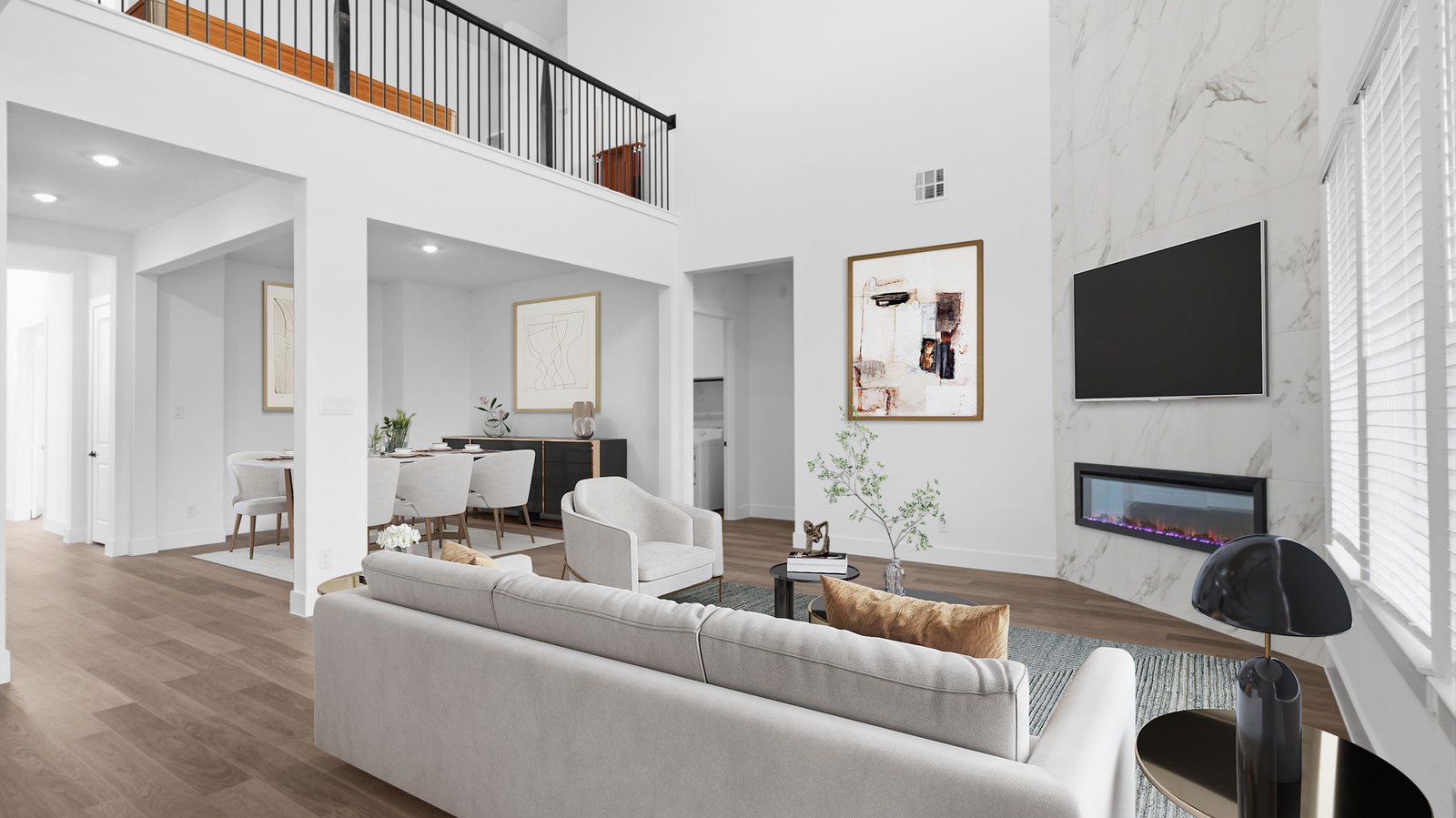 A luxurious living room featuring tall ceilings, large windows for natural lighting wood flooring and a view to the backyard.