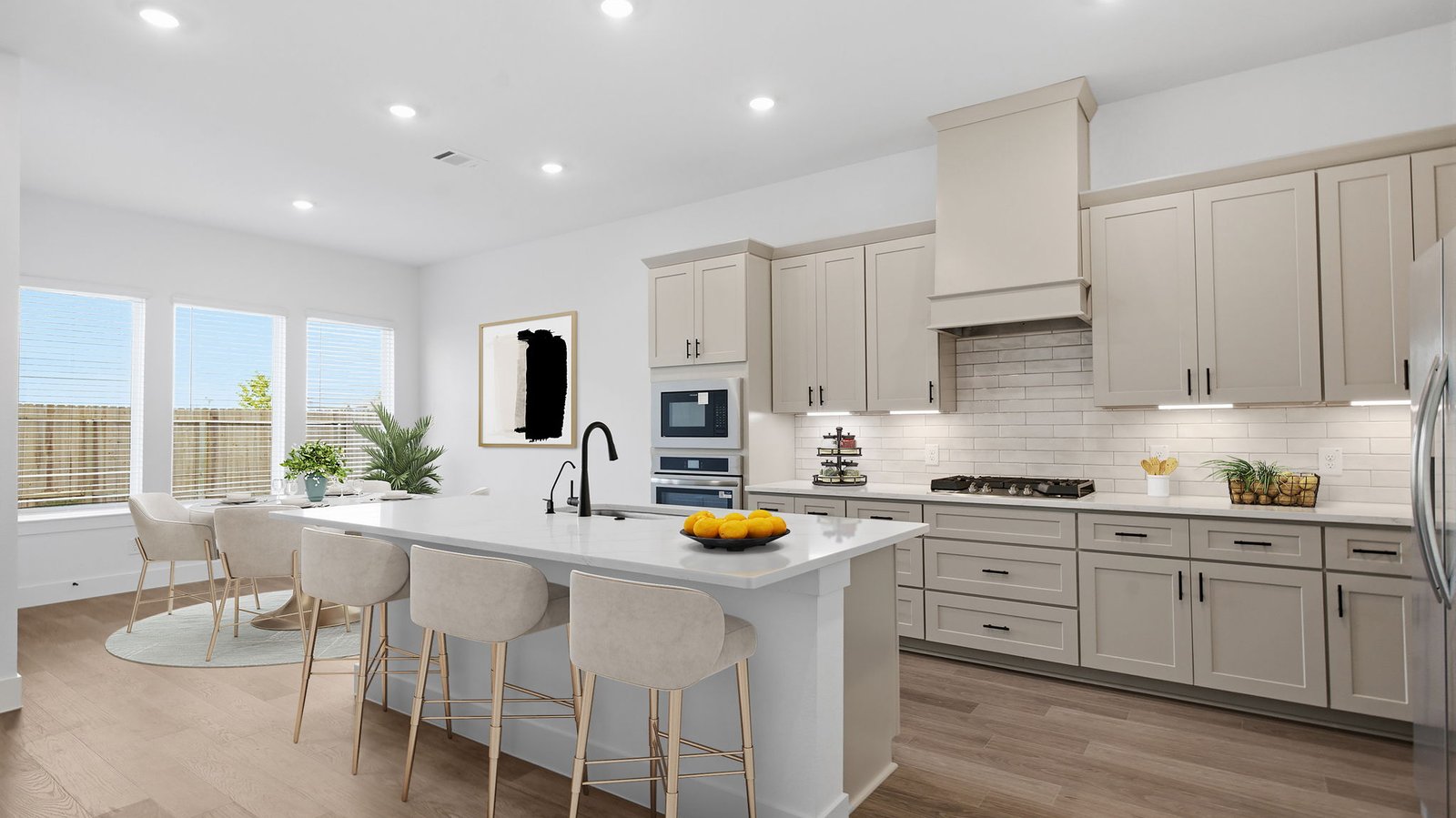 Bright and spacious kitchen with granite countertops, stainless steel appliances, and an island with bar seating.