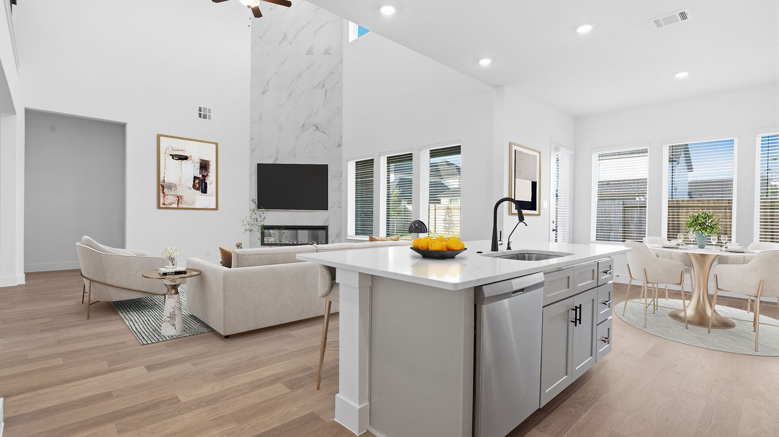An open concept kitchen with an island with bar seating and access to the living and dining areas.