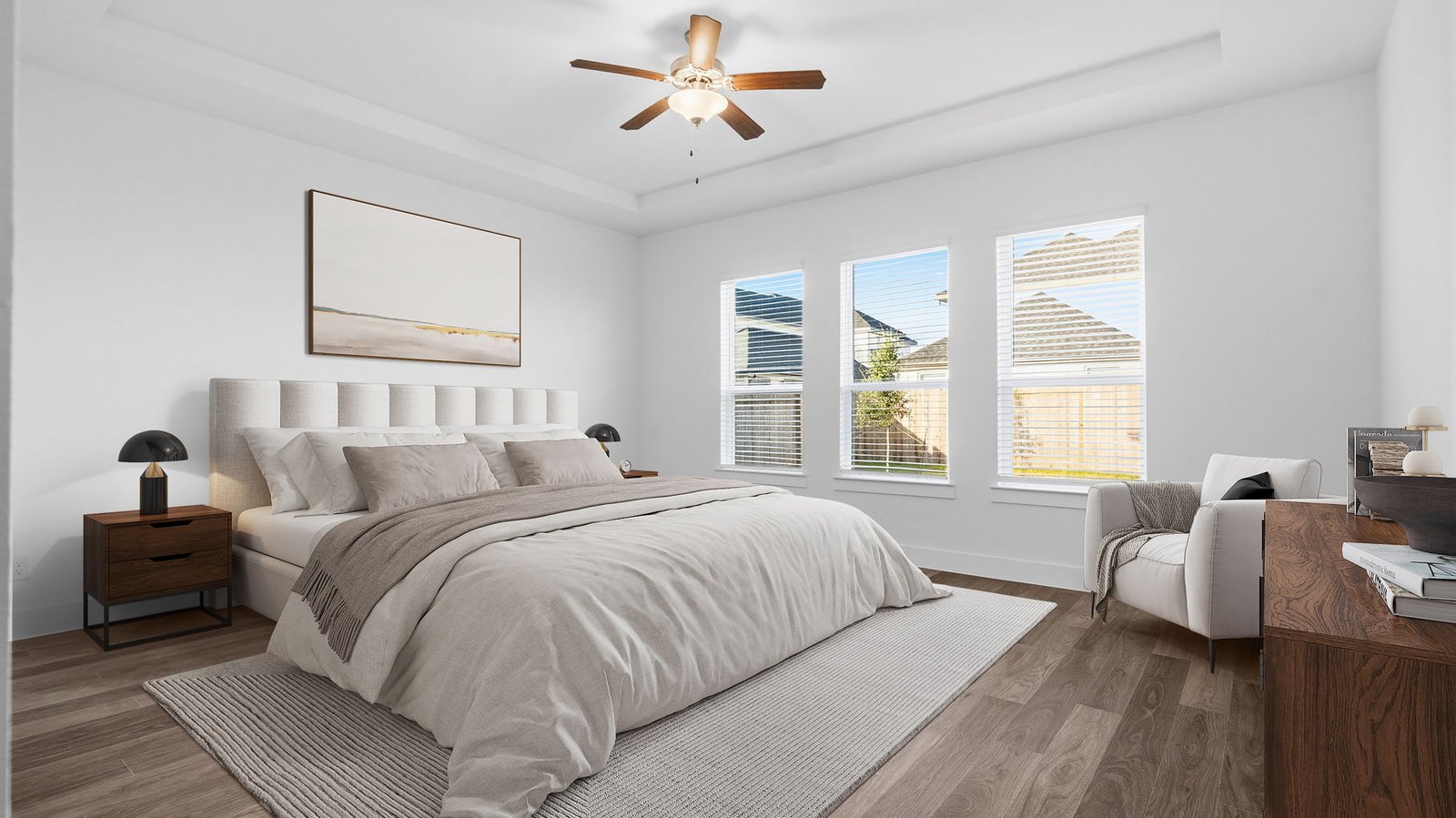 A spacious primary bedroom emphasizing open space and natural lighting with large windows.