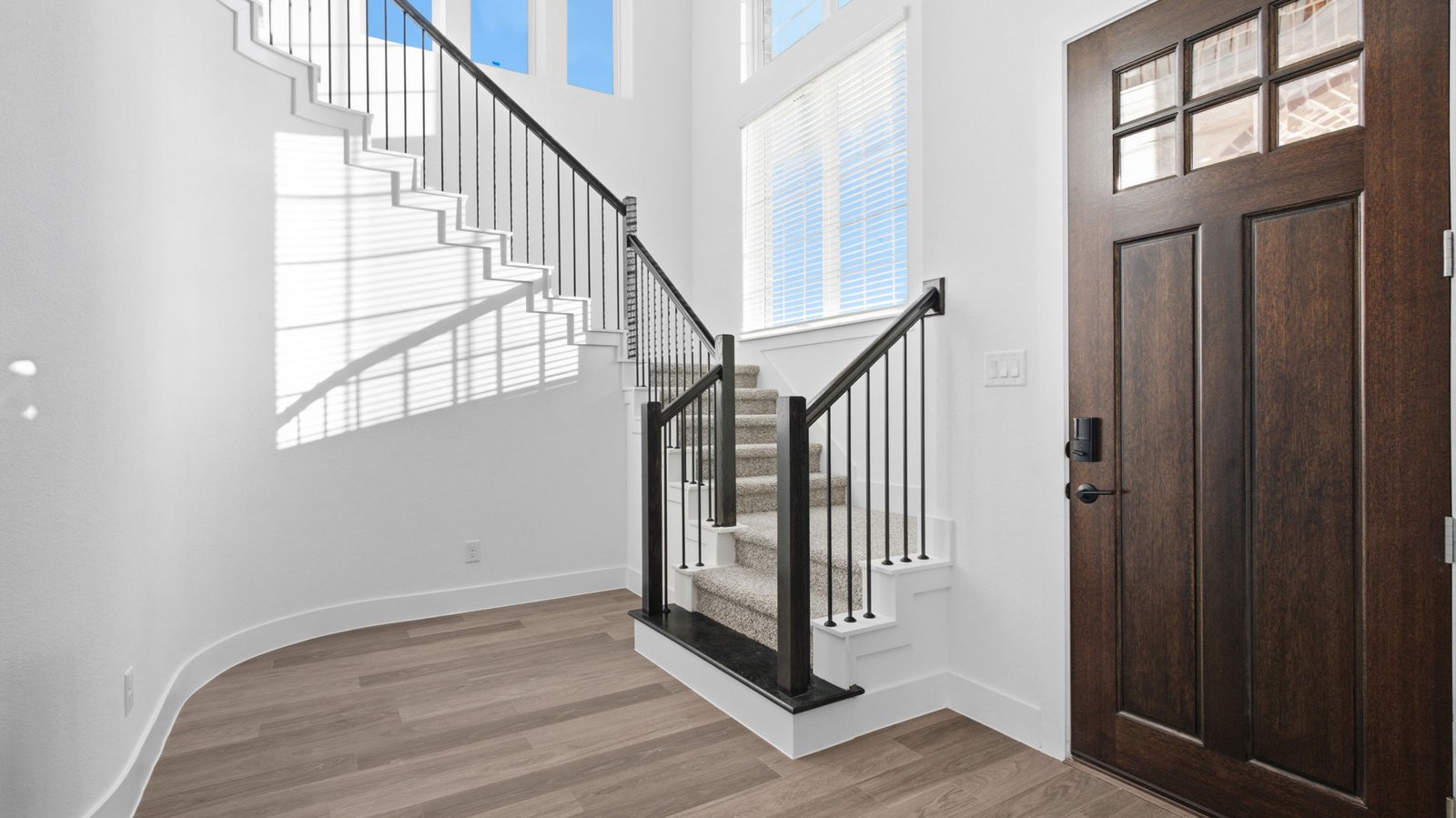 Spacious entry foyer with grand staircase leading to the second floor