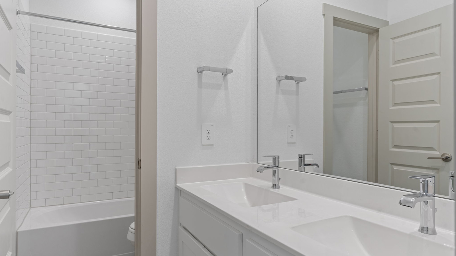 secondary bathroom with two sink