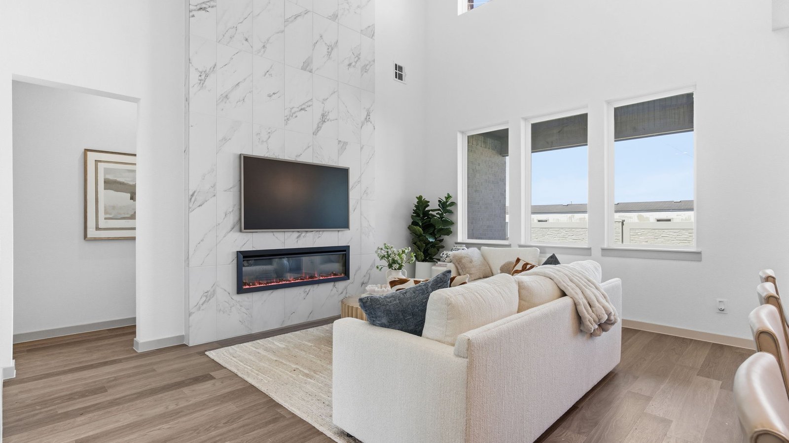 living room with fireplace and two large windows