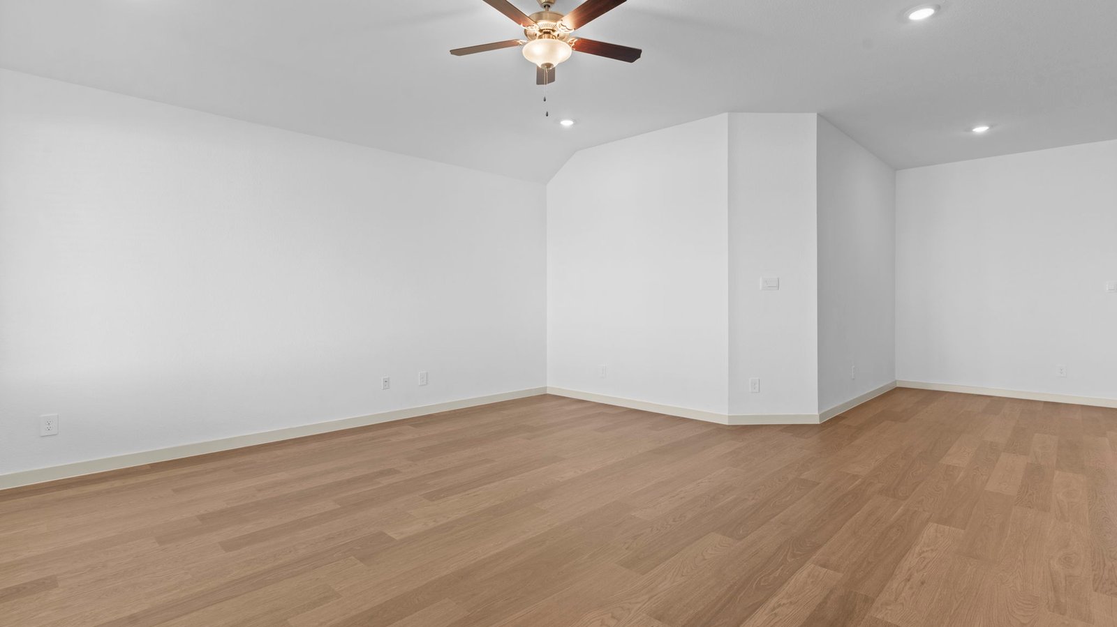 A well-organized living room that includes a kitchen and dining area, creating a warm and welcoming environment for gatherings.
