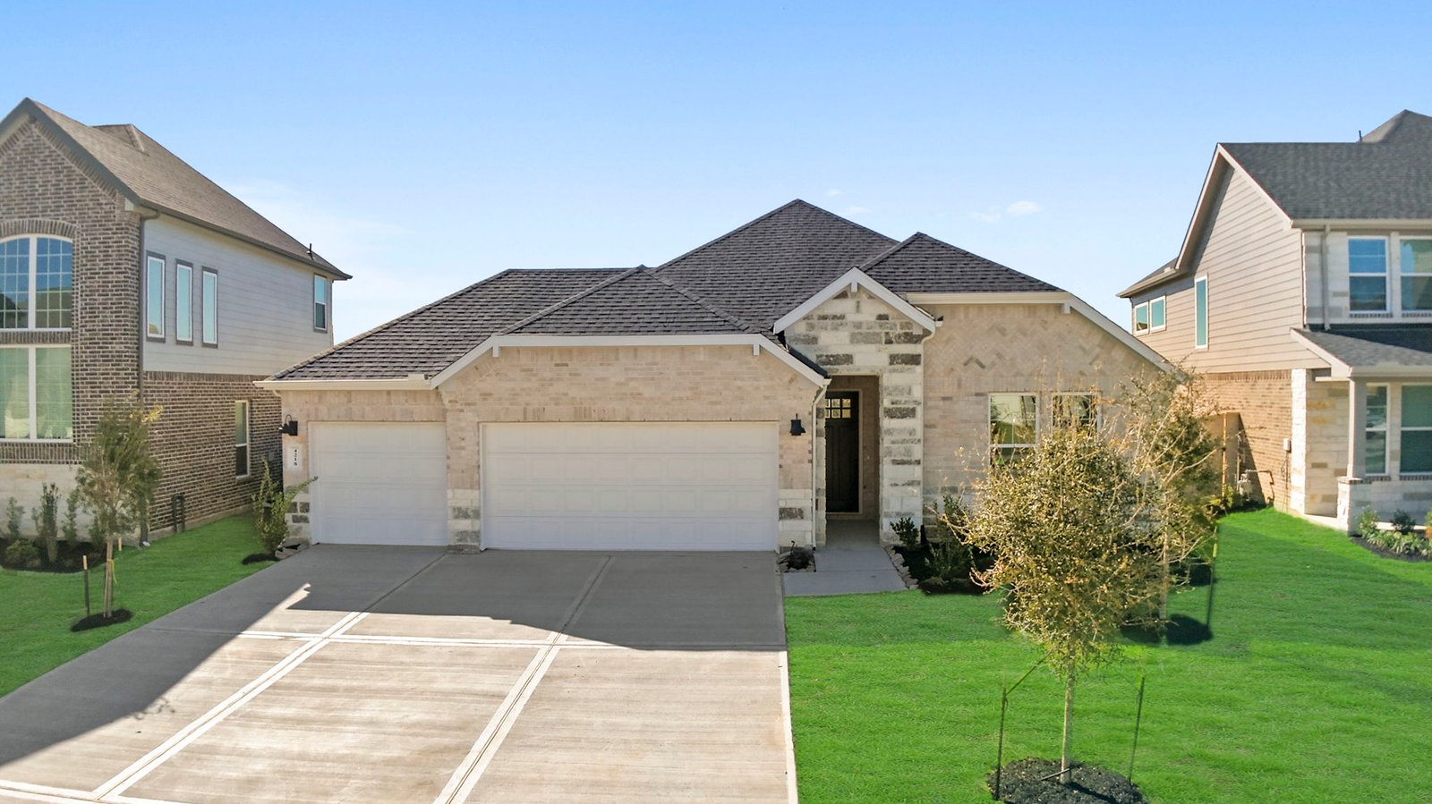 single story brick home with a two car garage