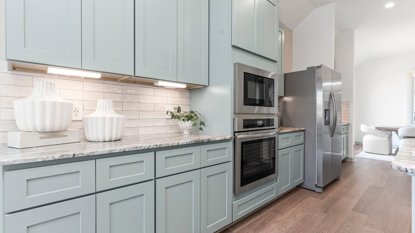 Bright and spacious kitchen with quartz countertops, stainless steel appliances, and an island with bar seating.