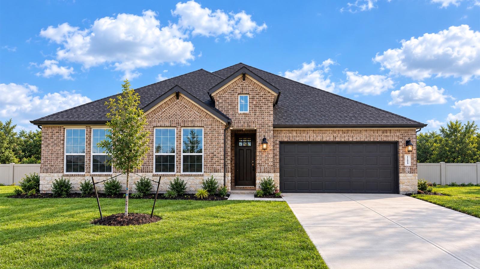Newly built single story home with traditional architecture, a double garage, and landscaped front yard.