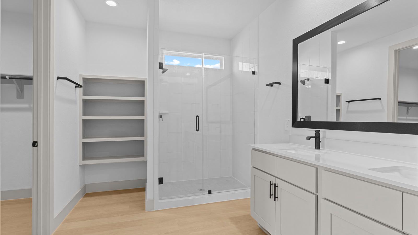 Primary bathroom with a glass-enclosed standing shower and separate soaking tub.