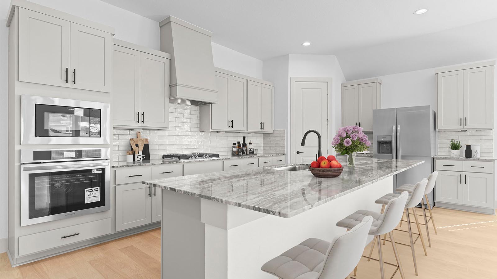 Kitchen adorned with painted cabinets seamlessly integrated into an open dining area layout.