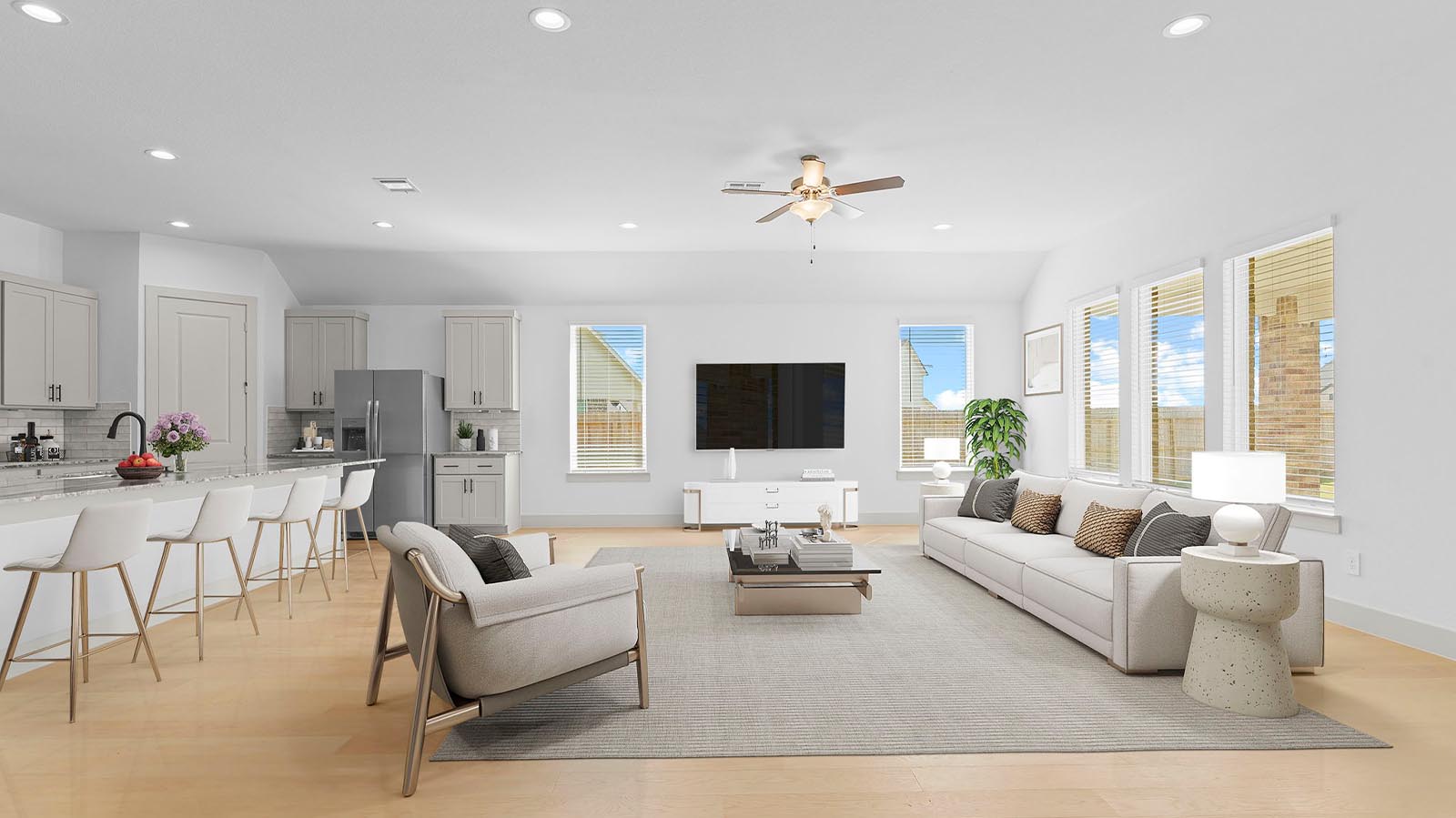 A well-organized living room that includes a kitchen and dining area, creating a warm and welcoming environment for gatherings.