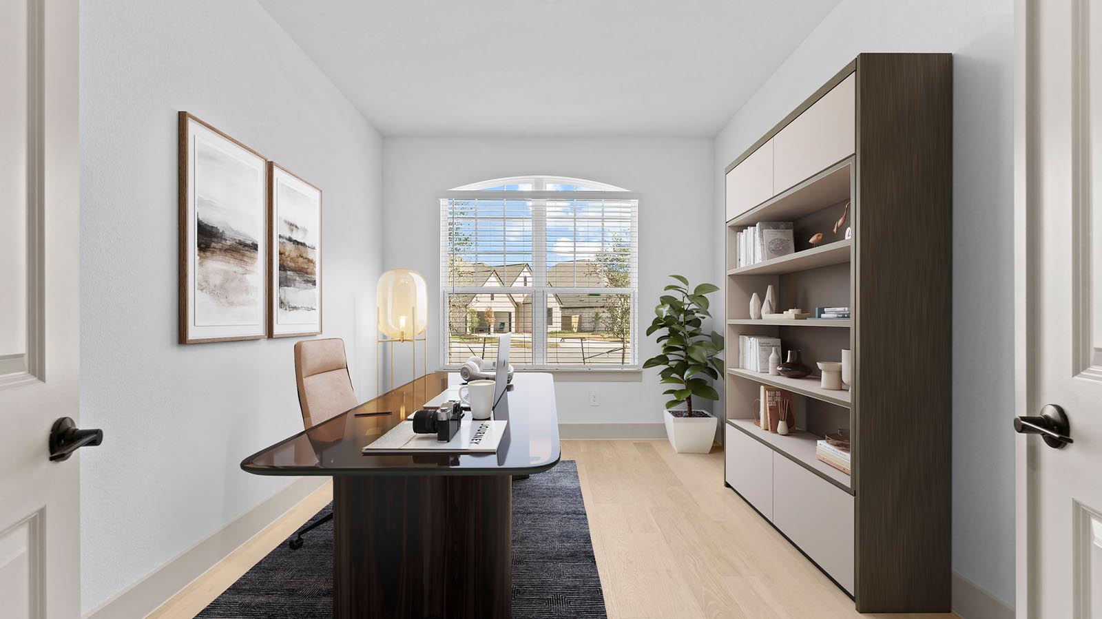 A tidy office featuring a desk, chair, and a window, creating a bright and organized workspace.