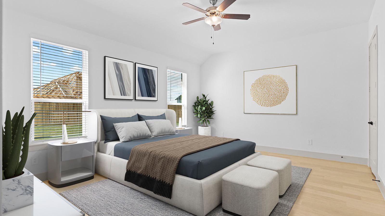 A spacious primary bedroom emphasizing open space and natural lighting with large windows.