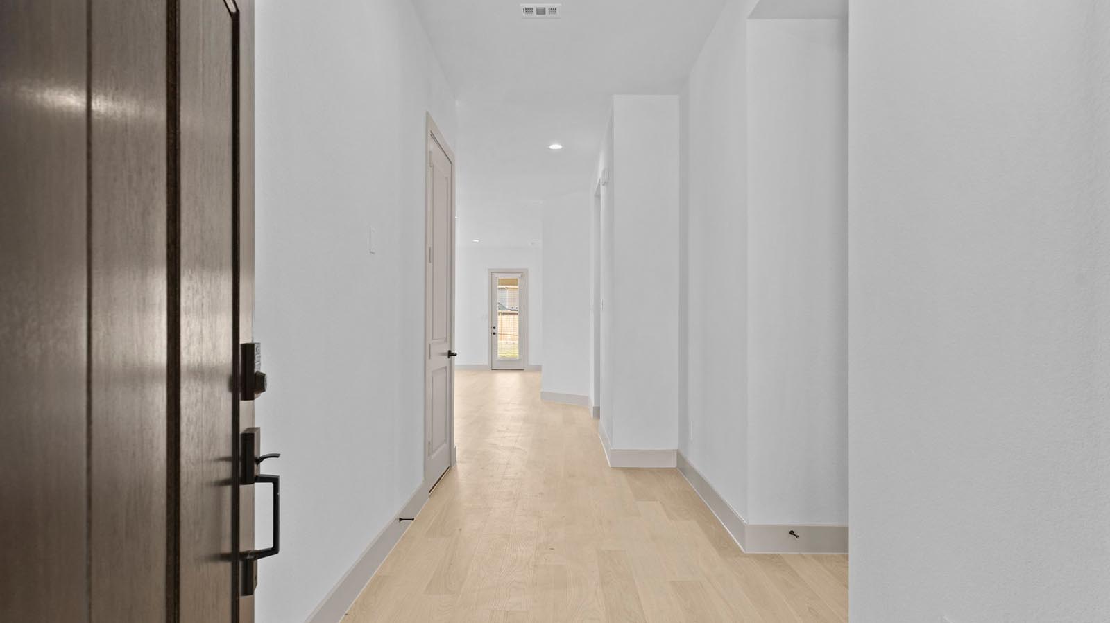 Entry hallway leading to living room and kitchen in the background.