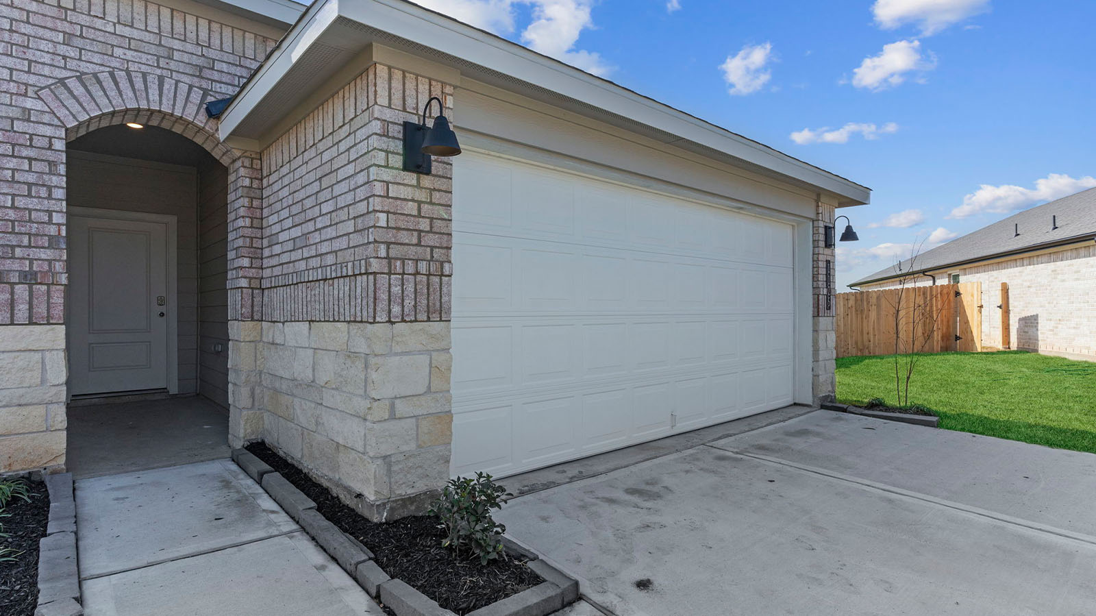 Single story brick home with a two car garage
