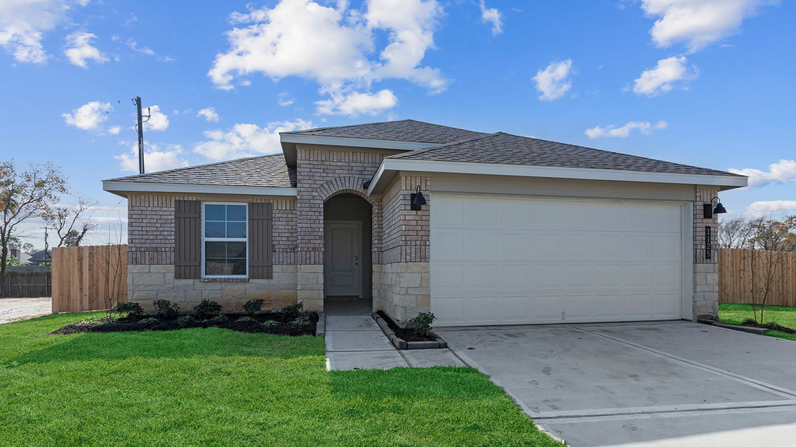 Single story brick home with a two car garage