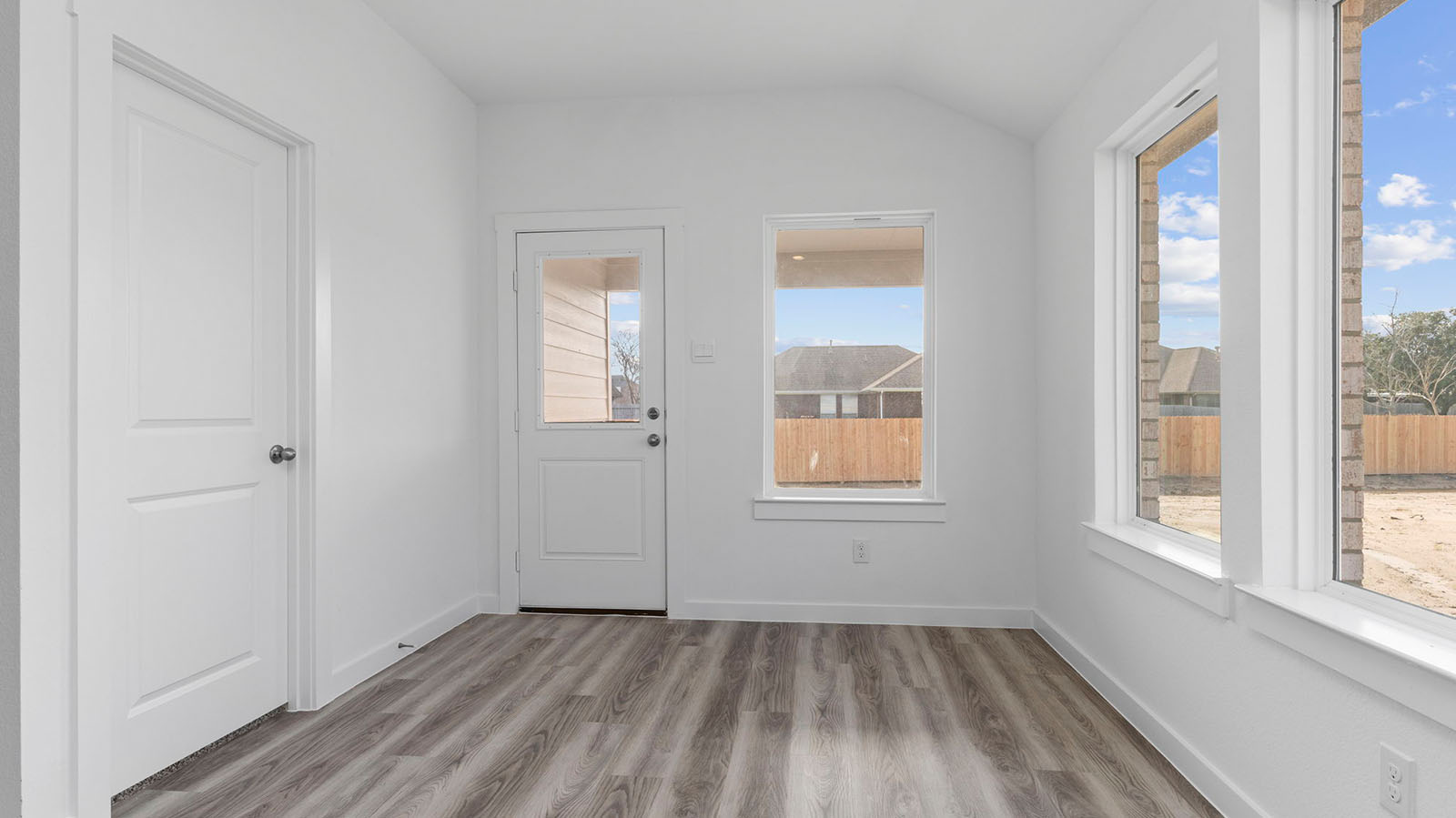 Dining room with three large windows and back patio door