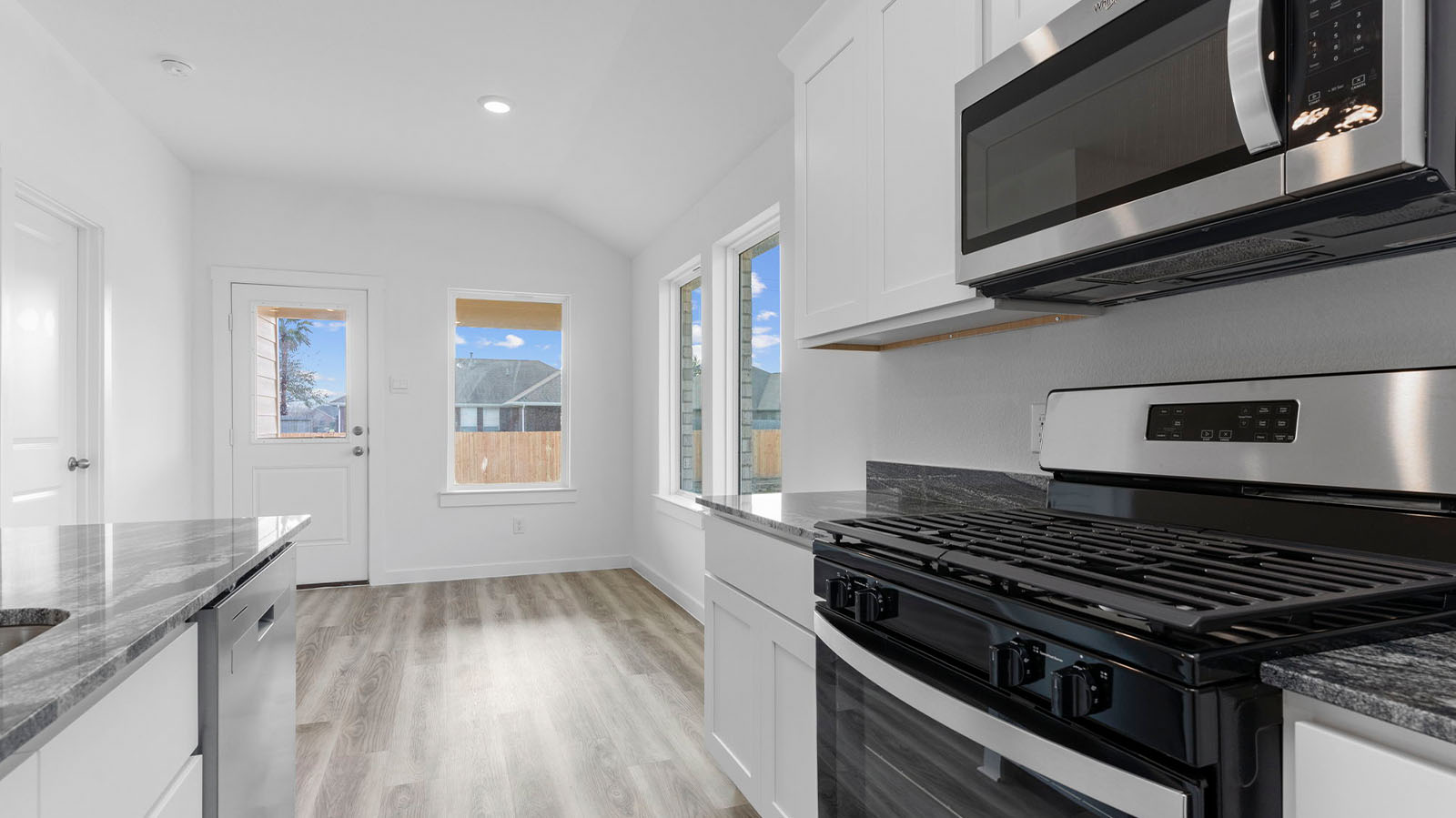 Open concept kitchen and dining room with stainless steel appliances