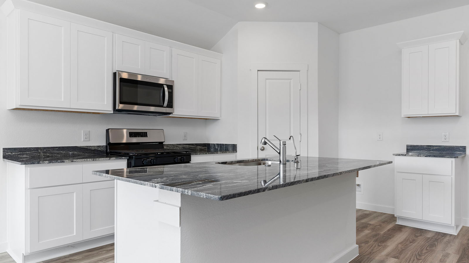 Kitchen with a large kitchen island with a deep sink