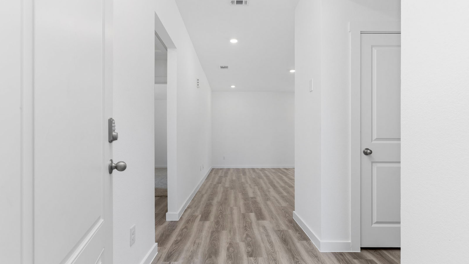 Entryway leading to a hallway to the secondary bedrooms