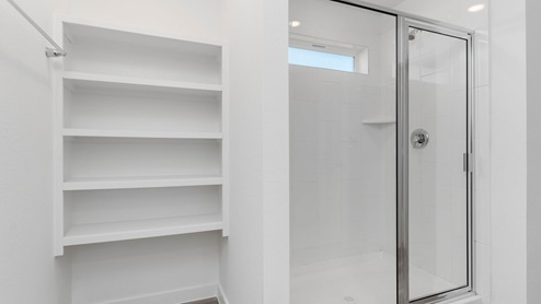 Primary bathroom with shower and open shelving