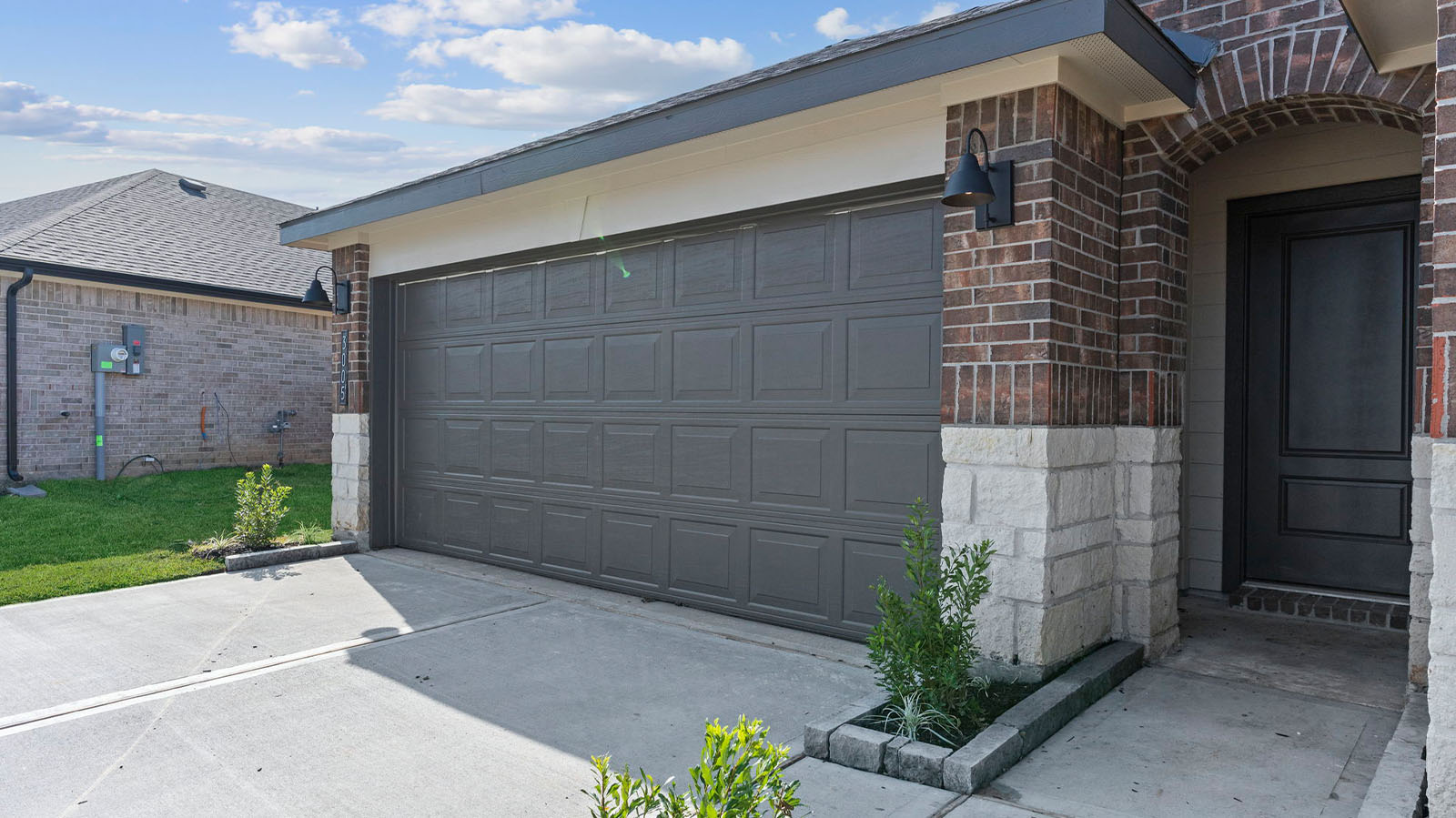 Single story brick home with a two car garage