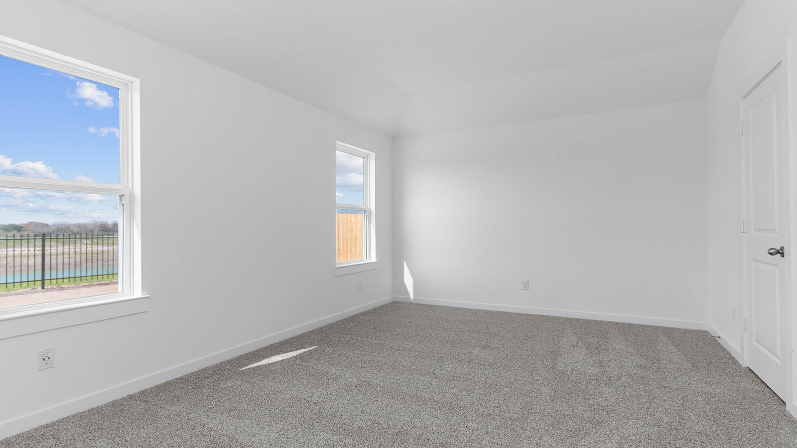 Primary bedroom with two large windows