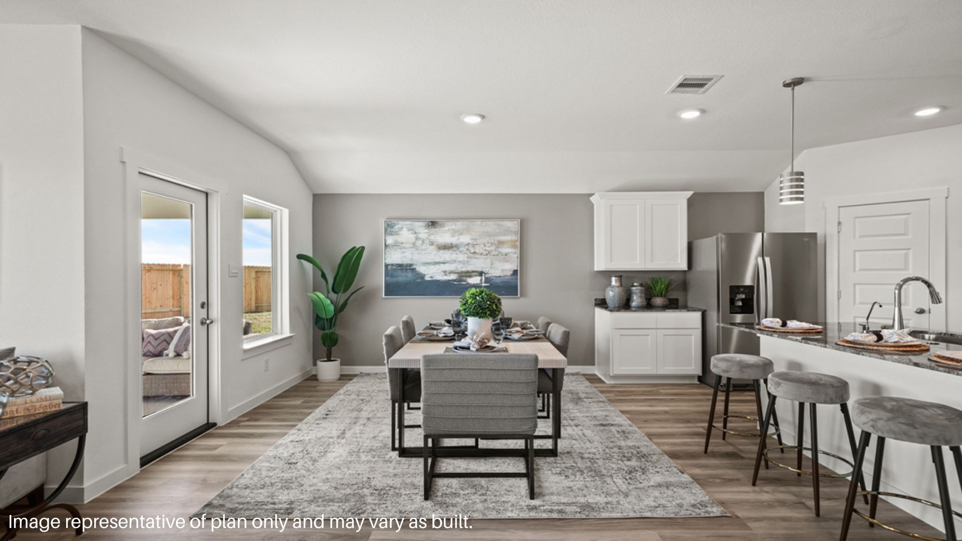 Open concept living and dining space with vinyl flooring.