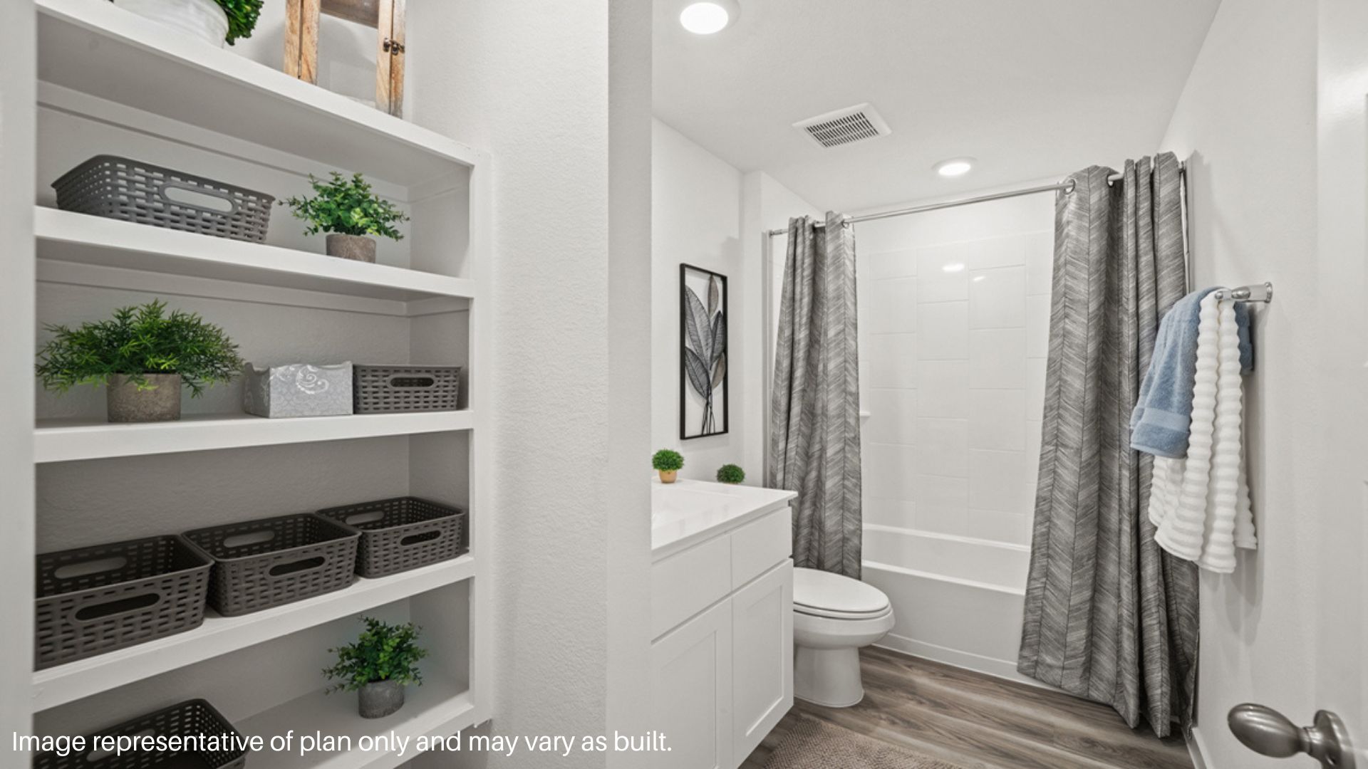 Secondary bedroom with tub and shower combo with built in linen nook.