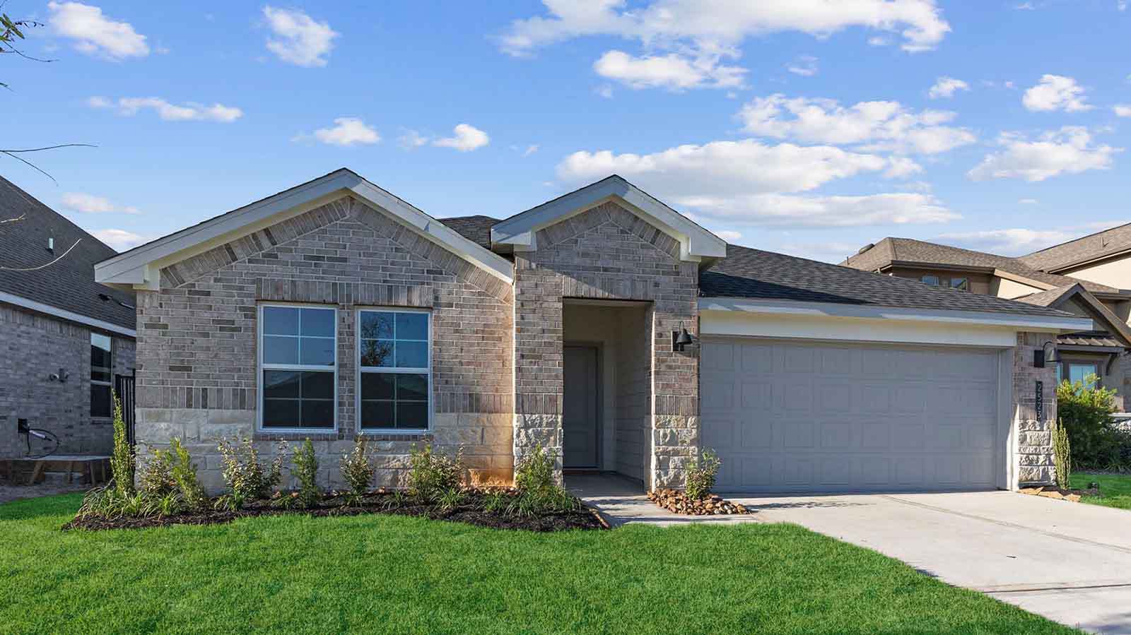 Single story brick home with a two car garage