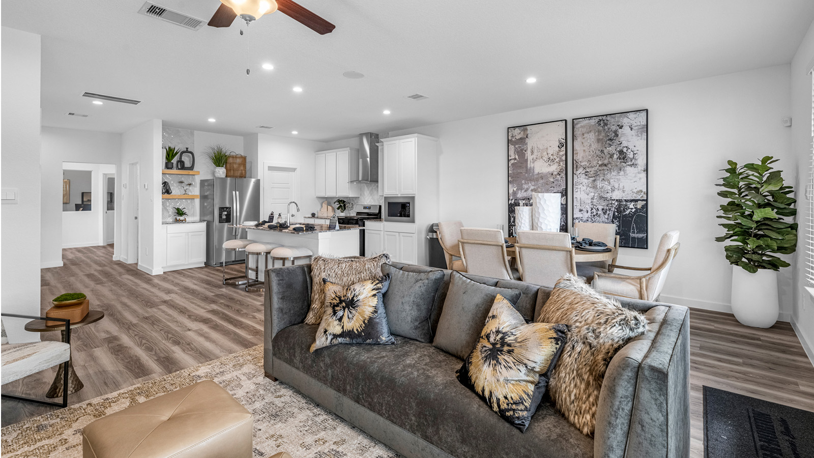 A well-organized living room that includes a kitchen and dining area, creating a warm and welcoming environment for gatherings.