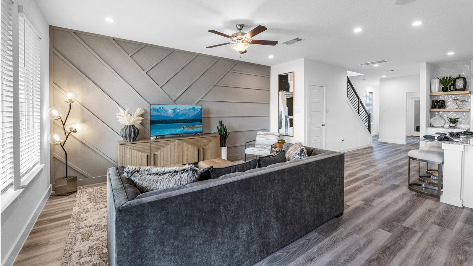A well-organized living room that includes a kitchen and dining area, creating a warm and welcoming environment for gatherings.
