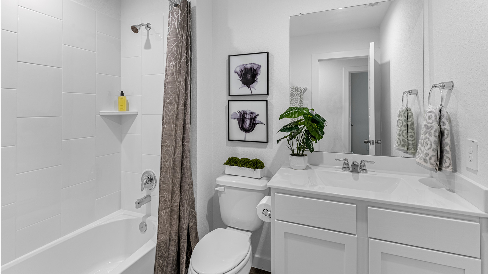 A well-designed bathroom equipped with granite countertops, a standing tub, and a single vanity.