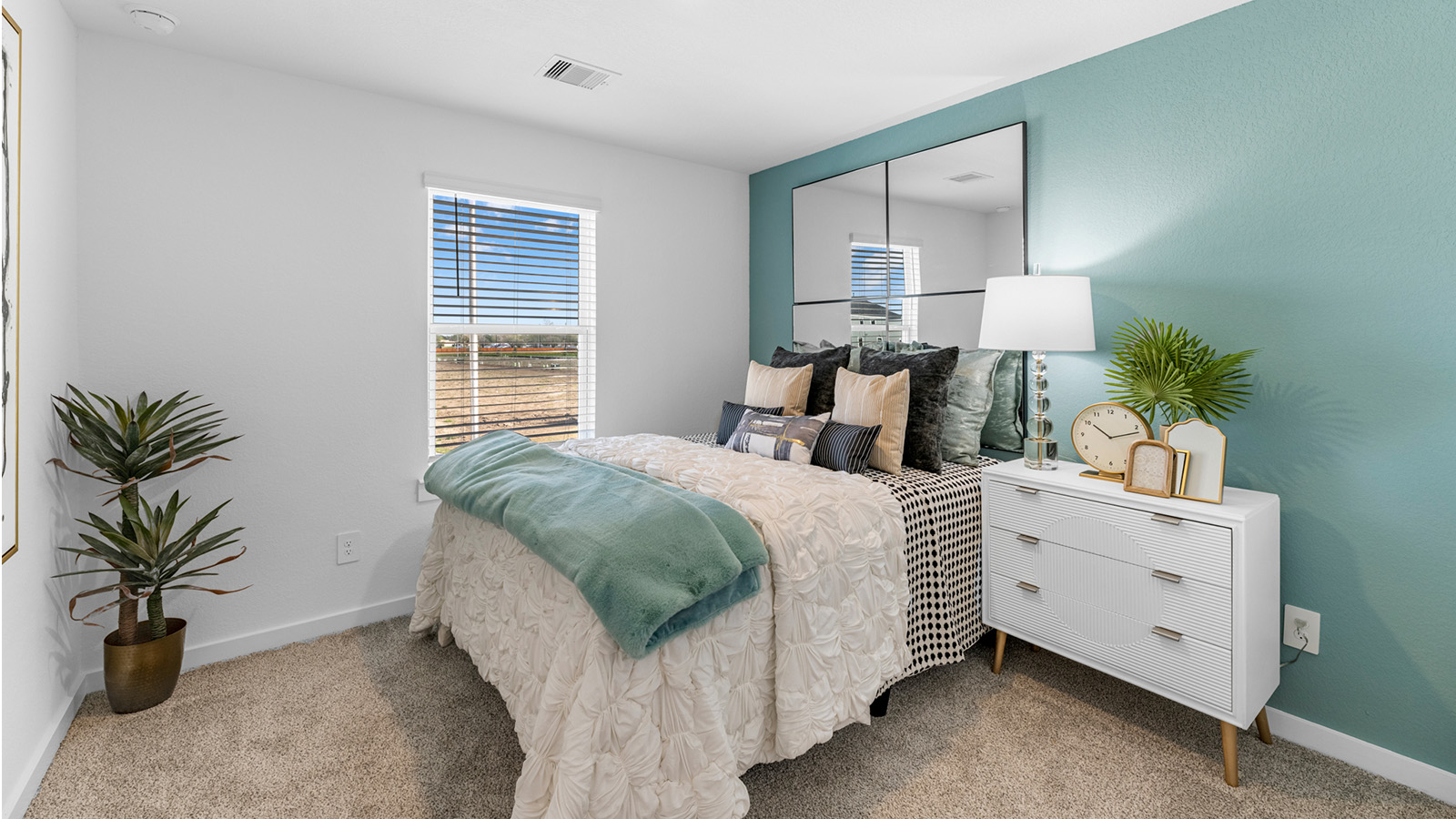 Comfortable guest bedroom featuring neutral-toned walls, carpeted flooring, and a separate closet.
