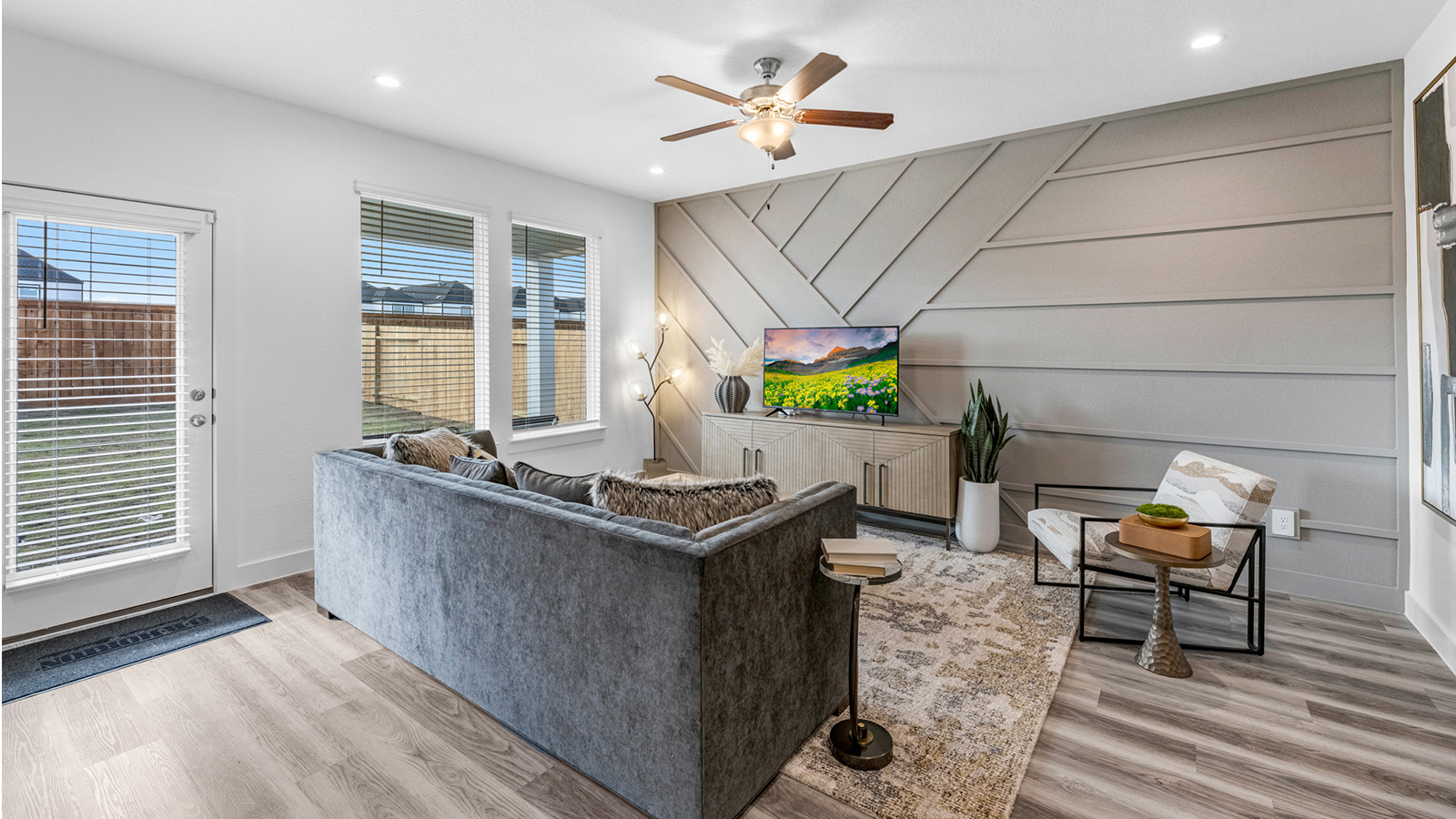 A well-organized living room that includes a kitchen and dining area, creating a warm and welcoming environment for gatherings.