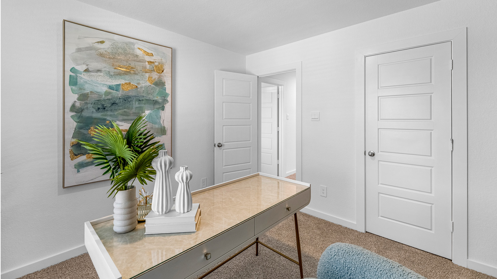 Comfortable guest bedroom featuring neutral-toned walls, carpeted flooring, and a separate closet.